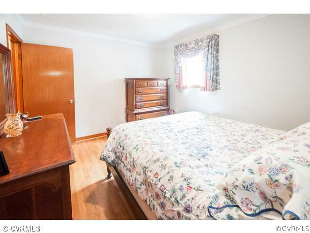 6433 Commander Road Richmond, VA 23224 - Photo 8 of 21 a bedroom with a bed and a window