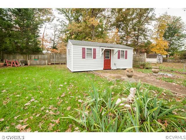 6433 Commander Road Richmond, VA 23224 - Photo 9 of 21 a view of a yard in front of a house with a large tree