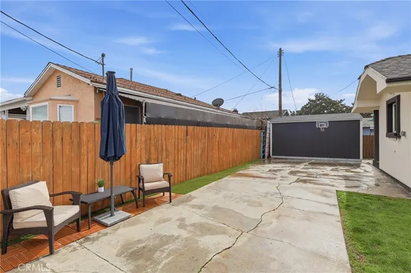 a backyard of a house with sofas