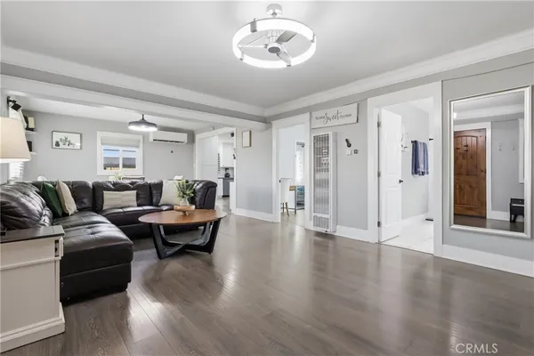 a living room with furniture and wooden floor