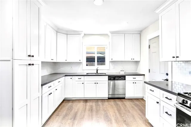 a kitchen with granite countertop white cabinets and white appliances