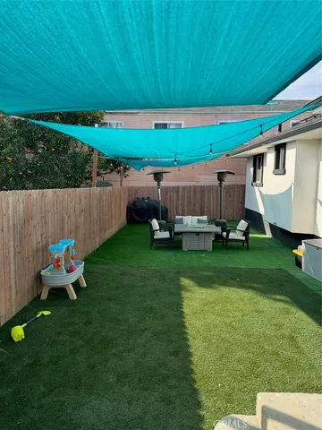 a backyard of a house with table and chairs