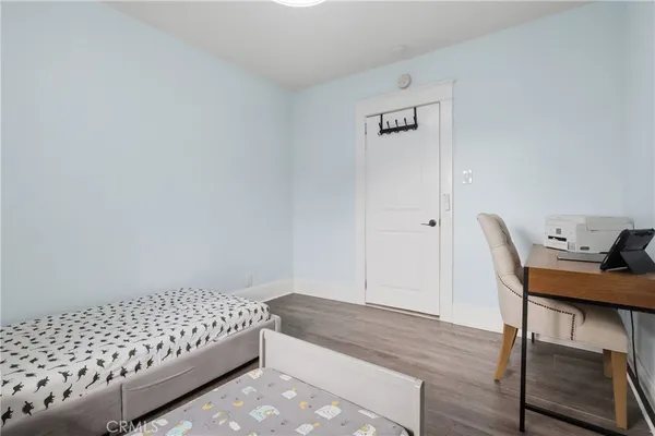 a bedroom with a bed and a desk