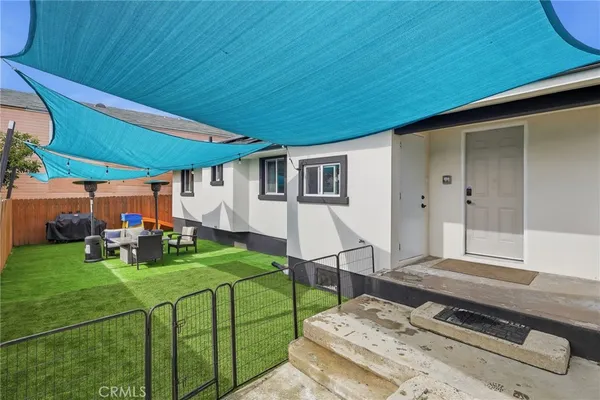 a view of a backyard with sitting area
