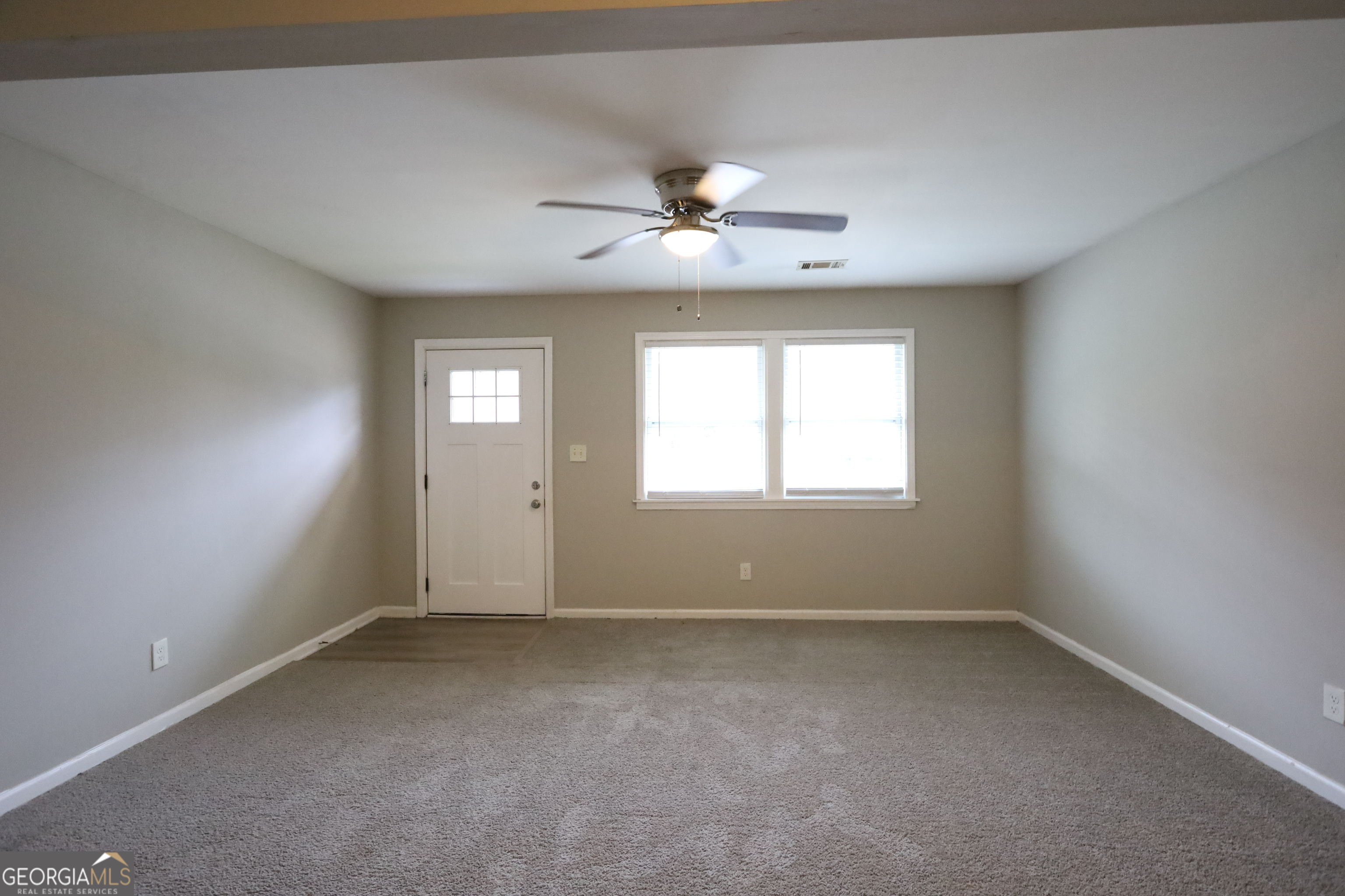 3410 Adkins Road Northwest Atlanta, GA 30331 - Photo 3 of 11 an empty room with a window and a fan