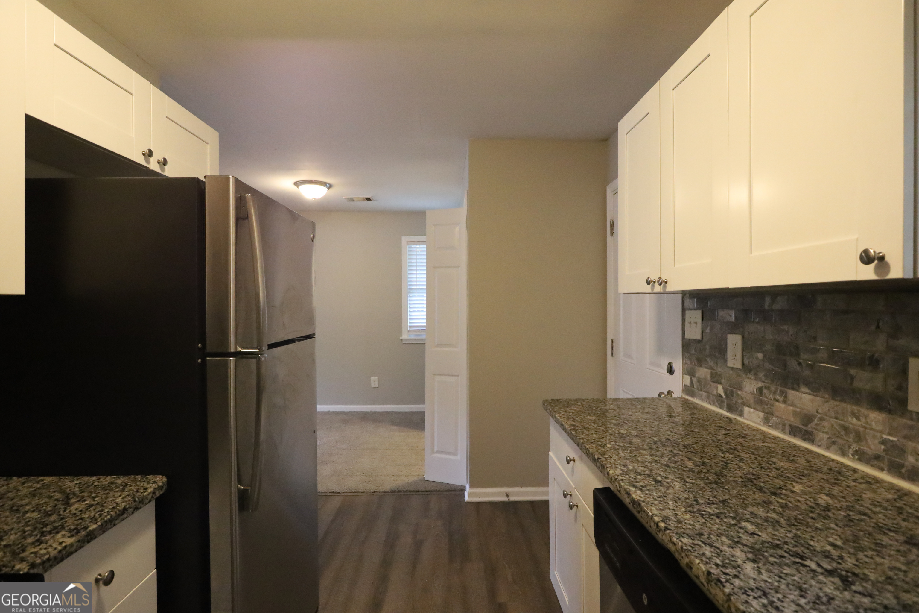 3410 Adkins Road Northwest Atlanta, GA 30331 - Photo 6 of 11 a kitchen with granite countertop a refrigerator and a sink