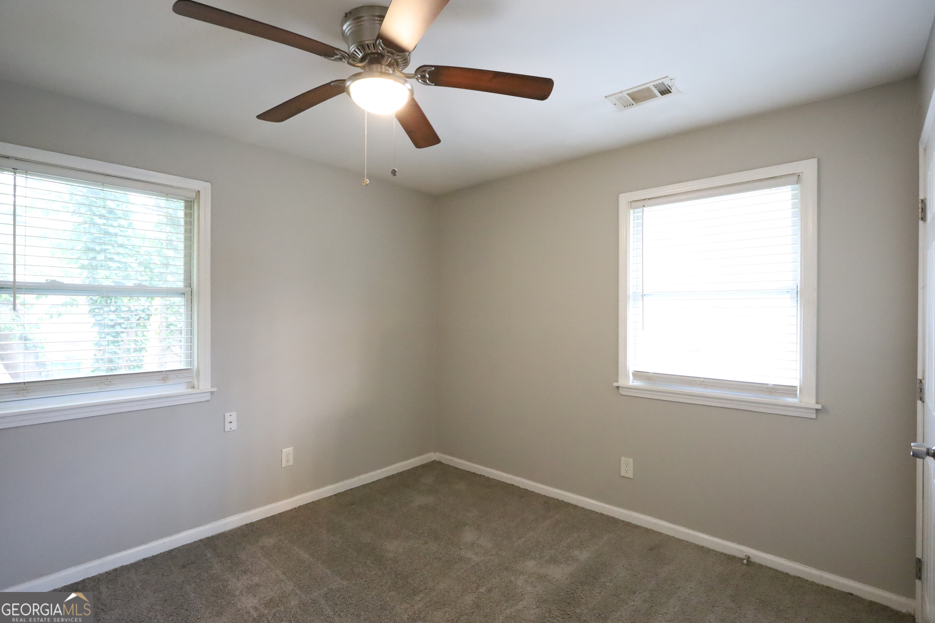 3410 Adkins Road Northwest Atlanta, GA 30331 - Photo 7 of 11 an empty room with a window and a fan