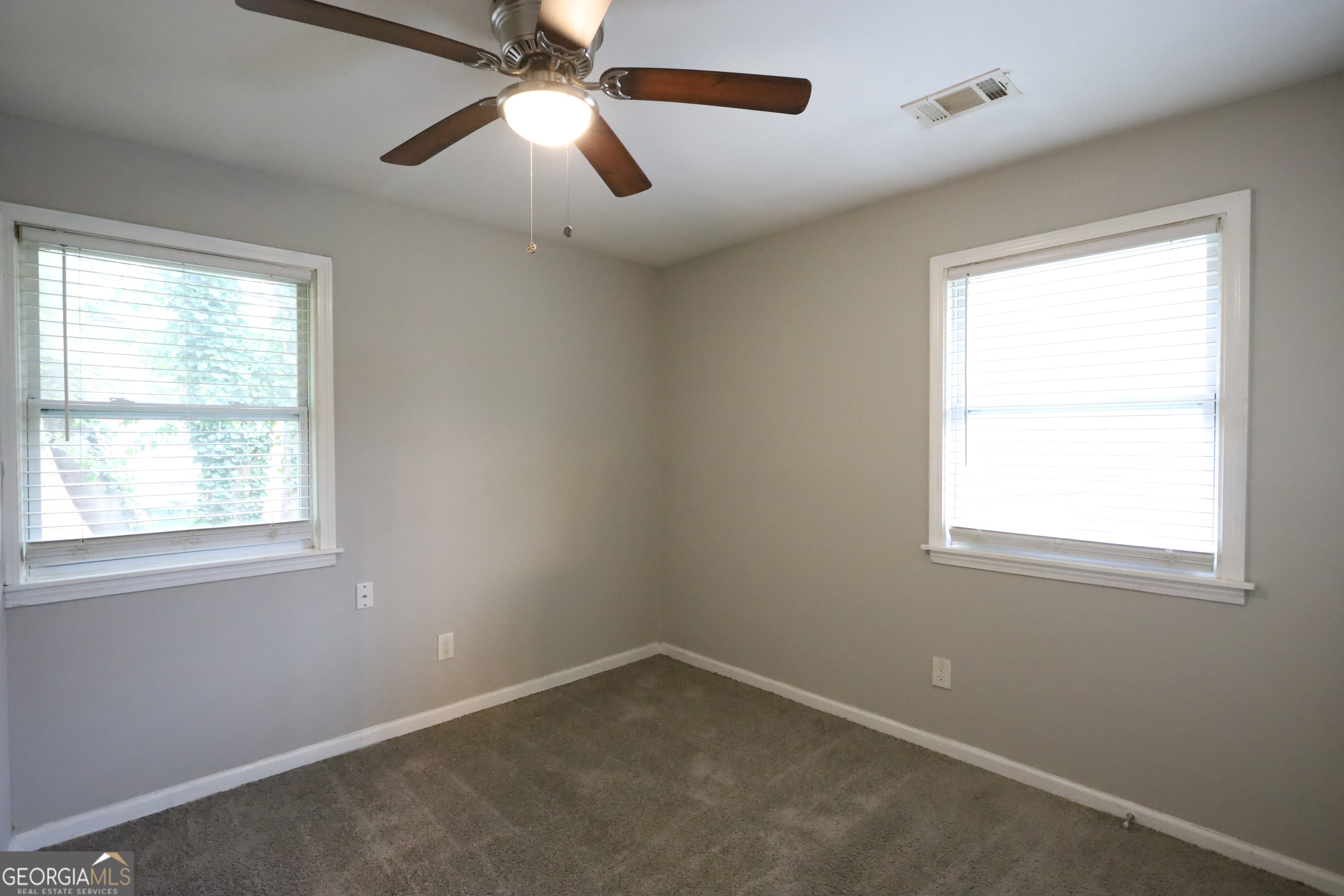 3410 Adkins Road Northwest Atlanta, GA 30331 - Photo 9 of 11 an empty room with a window and a fan