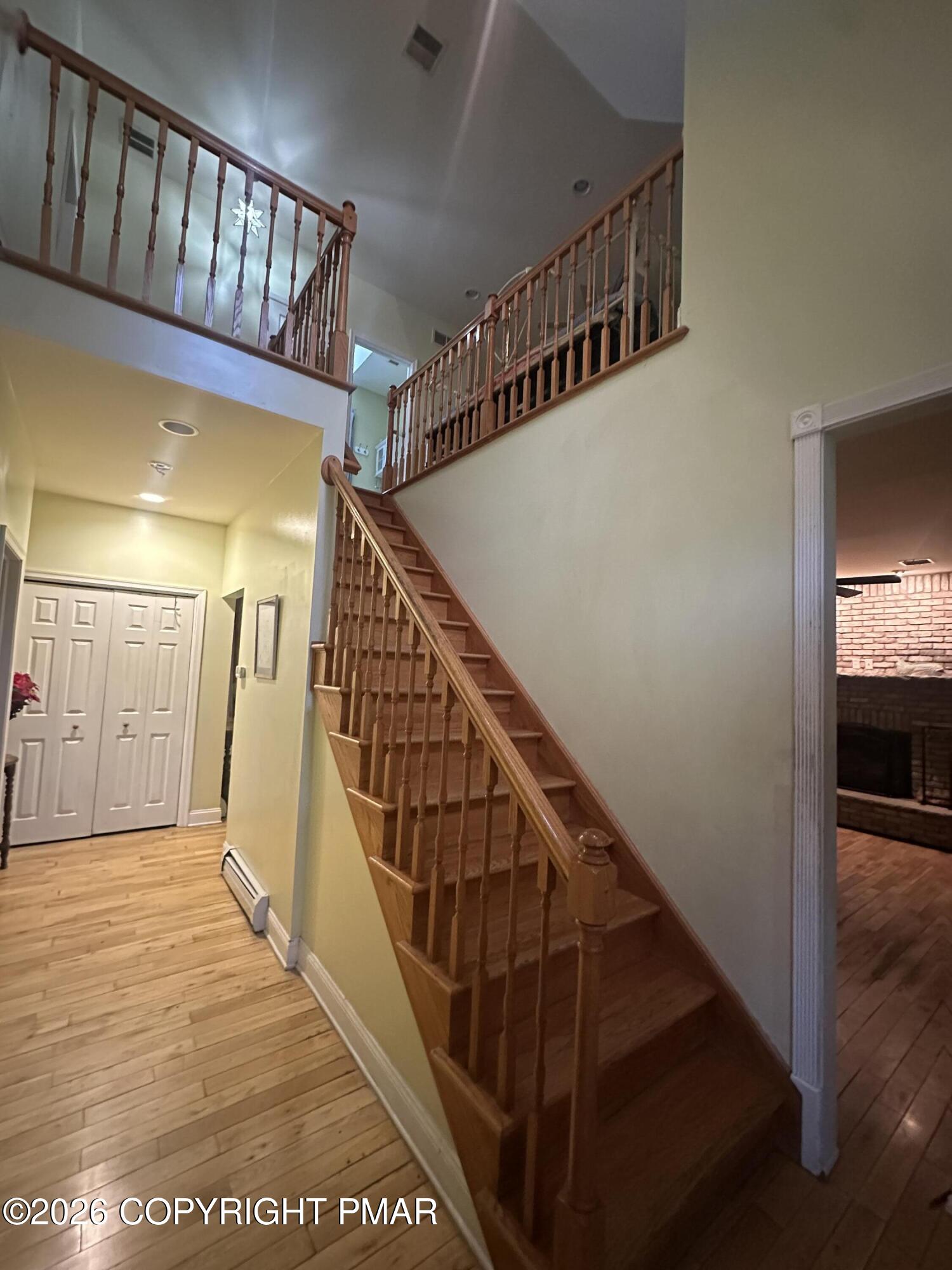 2 Shepard Court Delaware Water Gap, PA 18327 - Photo 19 of 57 a view of staircase with lots of frames on wall and wooden floor