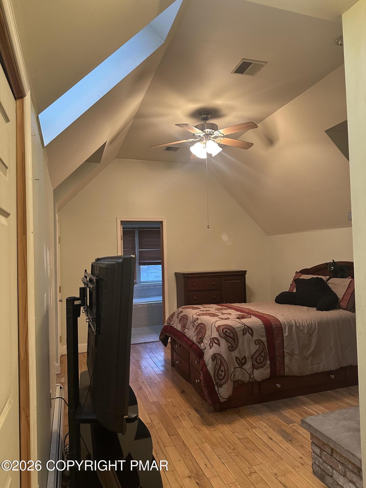 2 Shepard Court Delaware Water Gap, PA 18327 - Photo 41 of 57 a bedroom with a bed and a chandelier