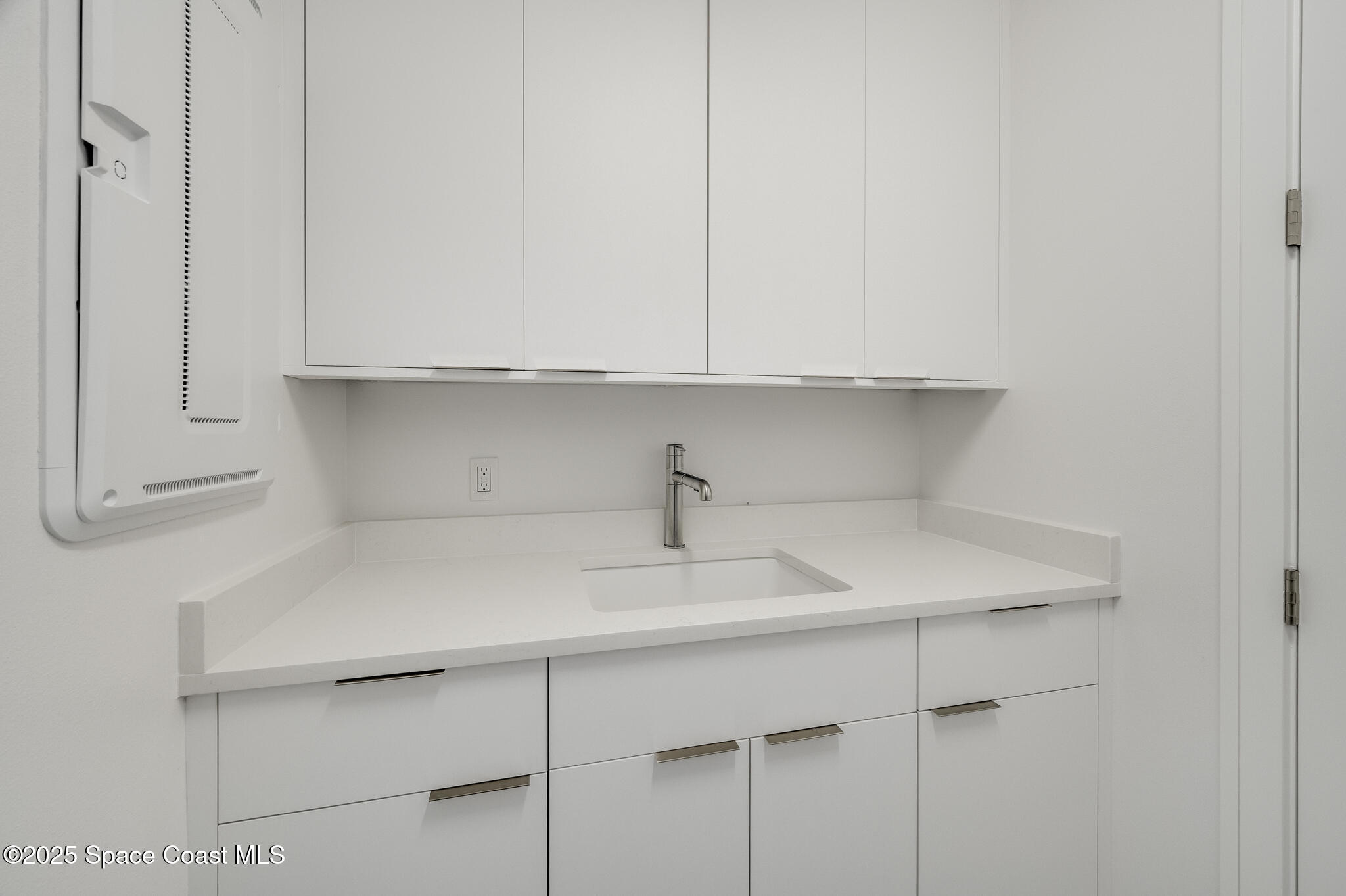 65 North Atlantic Avenue, Unit 404 Cocoa Beach, FL 32931 - Photo 16 of 57 Laundry sink