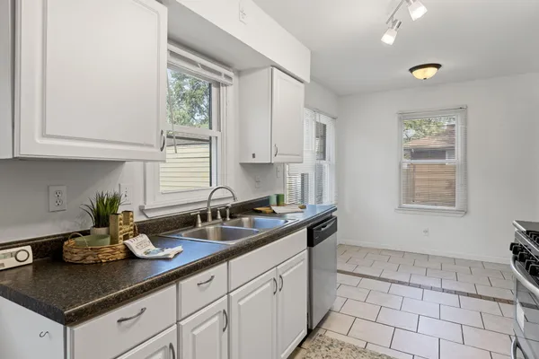 a kitchen with a sink cabinets and window