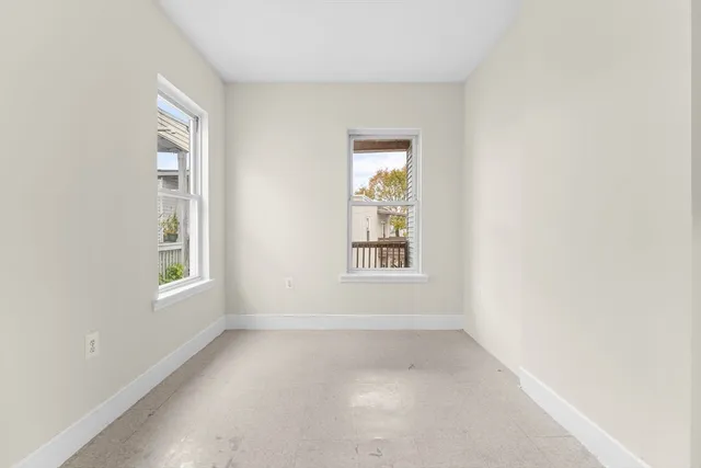 an empty room with windows and closet