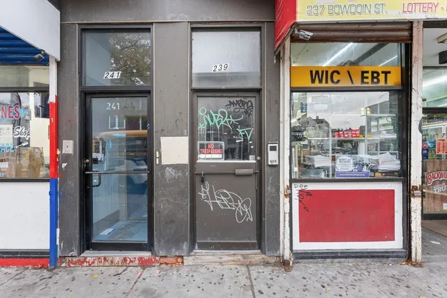 a view of water heater room with a refrigerator