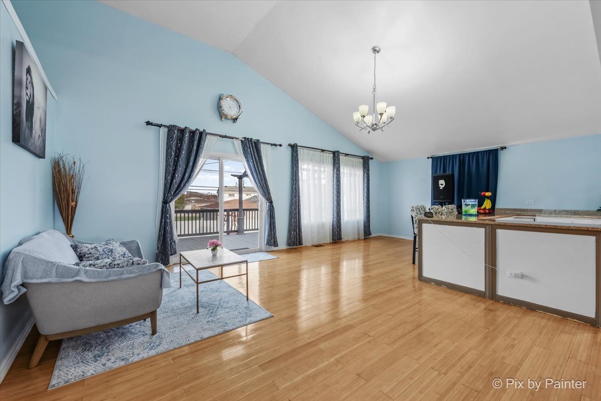 27 South Oltendorf Road Streamwood, IL 60107 - Photo 12 of 31 a living room with furniture a window and kitchen view