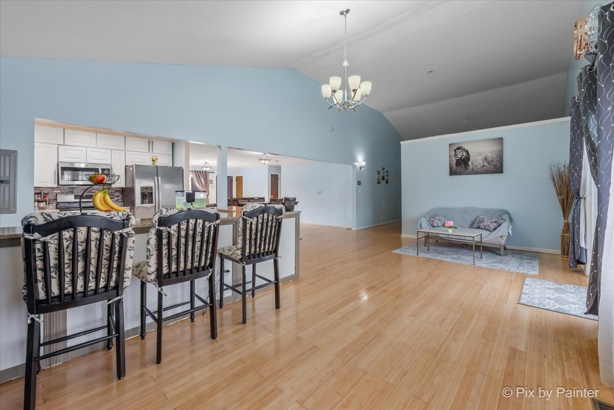 27 South Oltendorf Road Streamwood, IL 60107 - Photo 14 of 31 a view of a dining room with furniture and wooden floor