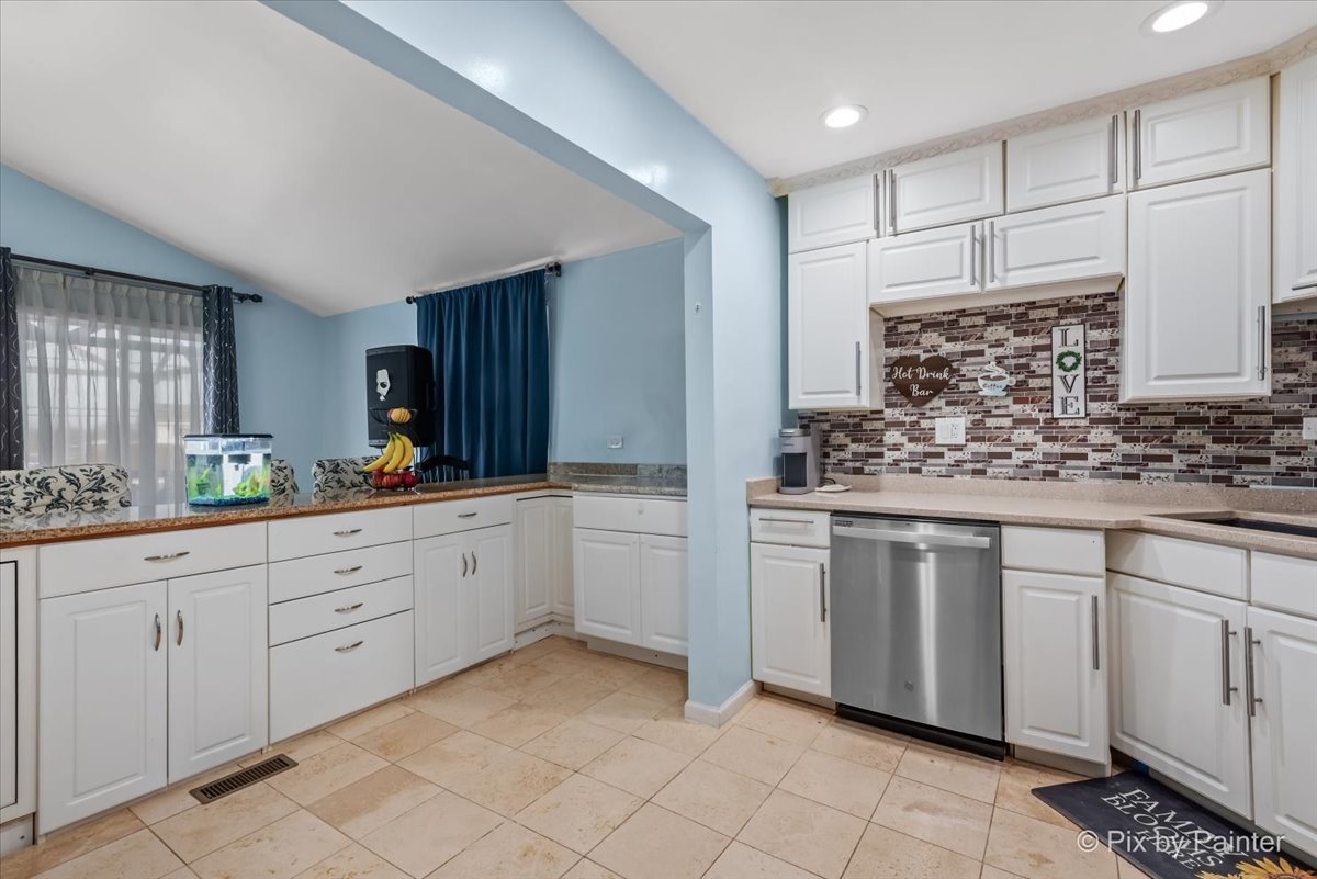 27 South Oltendorf Road Streamwood, IL 60107 - Photo 16 of 31 a kitchen with white cabinets and white appliances