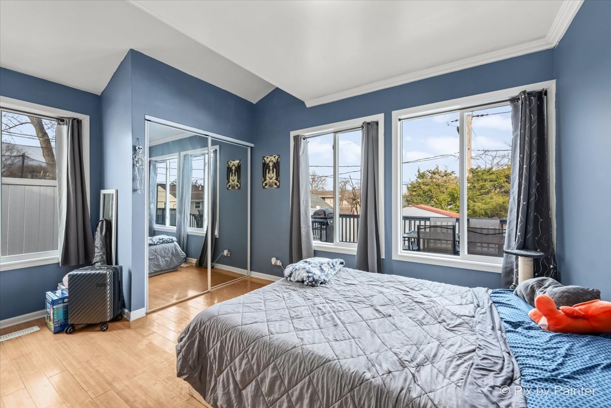 27 South Oltendorf Road Streamwood, IL 60107 - Photo 20 of 31 a bedroom with a bed and large windows