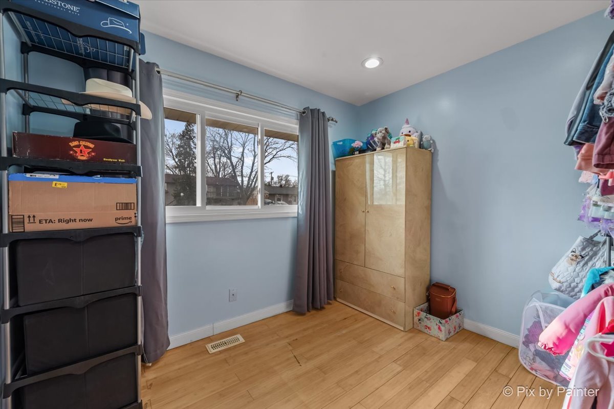 27 South Oltendorf Road Streamwood, IL 60107 - Photo 2 of 31 a bedroom with a bed and a window