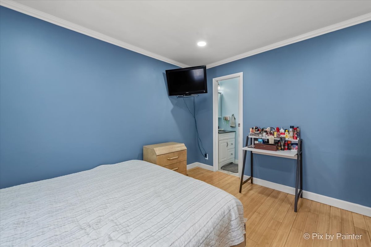 27 South Oltendorf Road Streamwood, IL 60107 - Photo 5 of 31 a bedroom with a bed and a flat screen tv