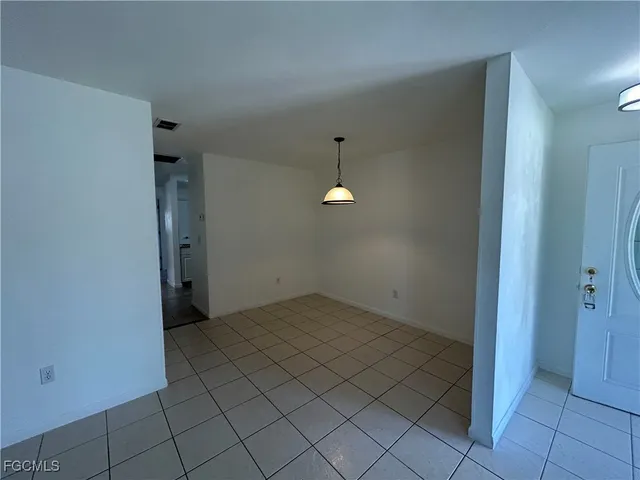 wooden floor in an empty room with a bathroom
