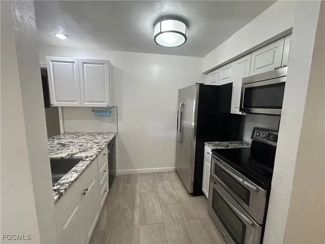 a kitchen with a refrigerator stove and microwave