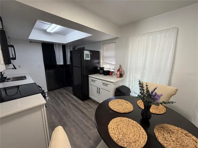 a living room with furniture and kitchen view