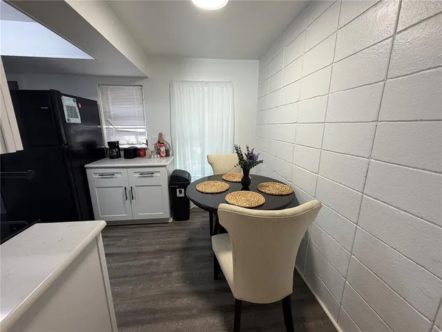 a living room with a sink a mirror and a rug