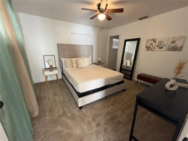 a bedroom with a bed and a chandelier