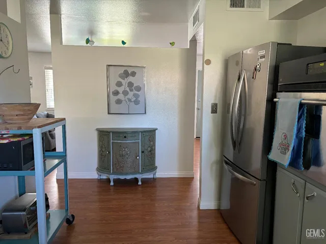 a kitchen with stainless steel appliances granite countertop a refrigerator and a stove