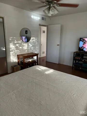 a bedroom with furniture and chandelier