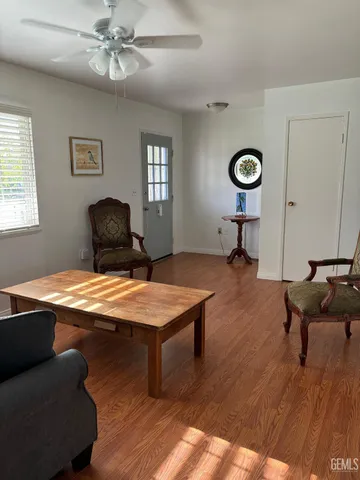a living room with furniture a table and window