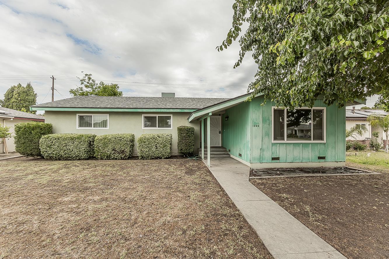 1350 Mill Street Selma, CA 93662 - Photo 1 of 47 a front view of a house with a garden