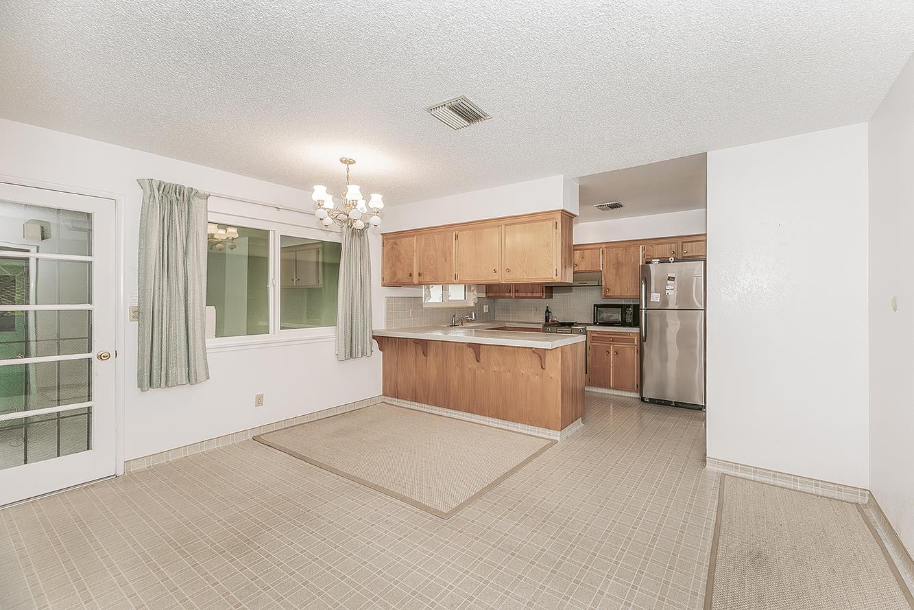 1350 Mill Street Selma, CA 93662 - Photo 11 of 47 a large kitchen with a large window and stainless steel appliances