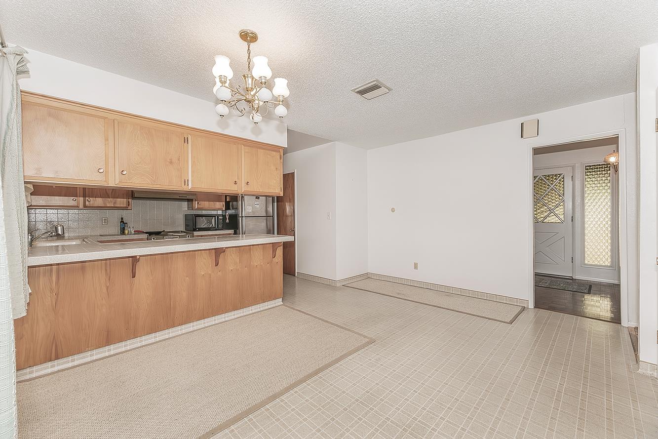 1350 Mill Street Selma, CA 93662 - Photo 12 of 47 a kitchen with stainless steel appliances granite countertop a refrigerator a sink dishwasher and white cabinets with wooden floor
