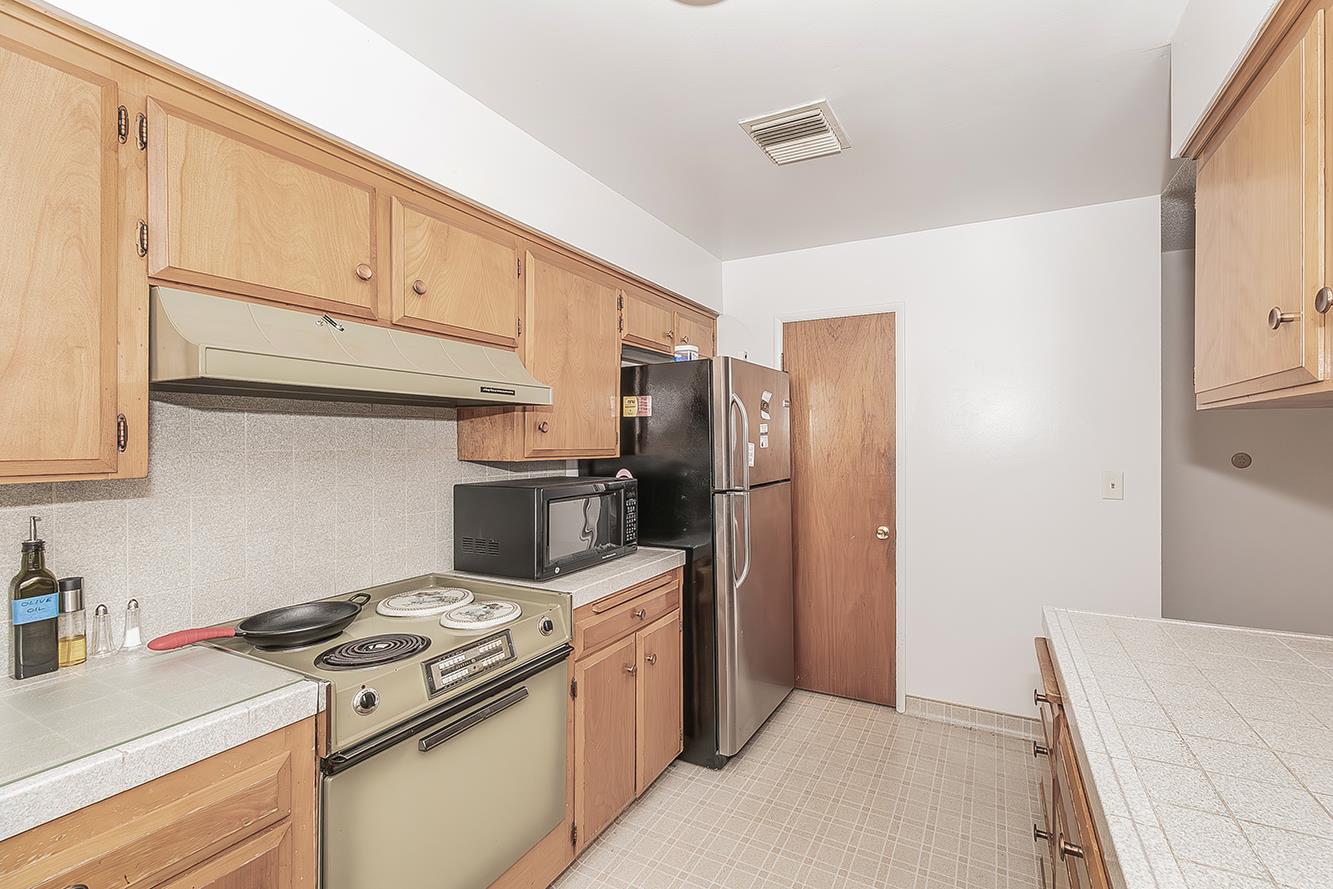 1350 Mill Street Selma, CA 93662 - Photo 15 of 47 a kitchen with a refrigerator stove and cabinets