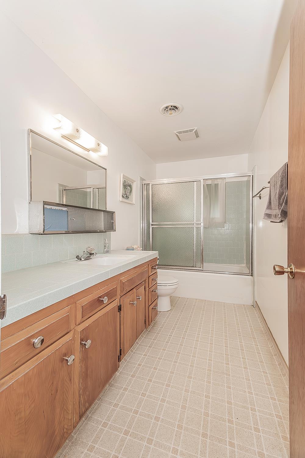 1350 Mill Street Selma, CA 93662 - Photo 24 of 47 a large white room with a large mirror and cabinets