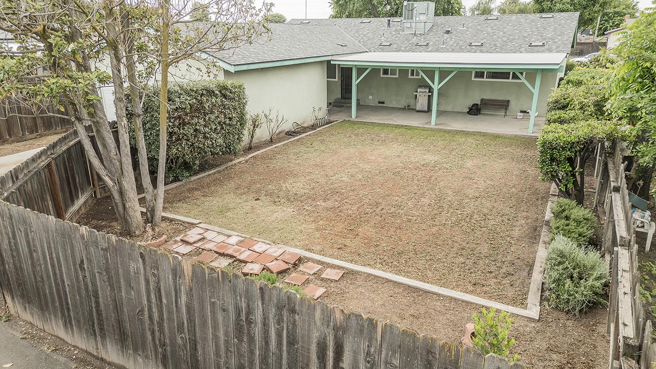 1350 Mill Street Selma, CA 93662 - Photo 39 of 47 a view of a house with backyard and trees