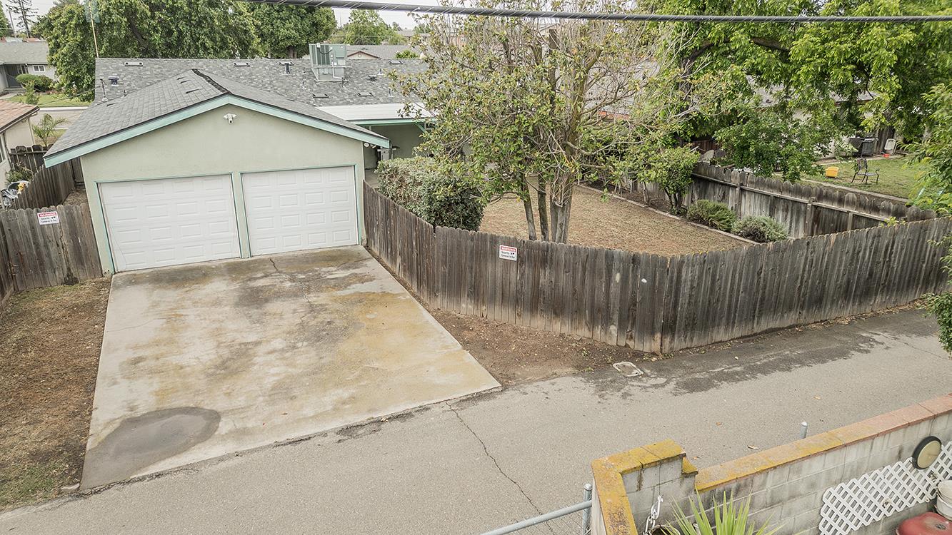 1350 Mill Street Selma, CA 93662 - Photo 41 of 47 a view of a small house with a fence in the background