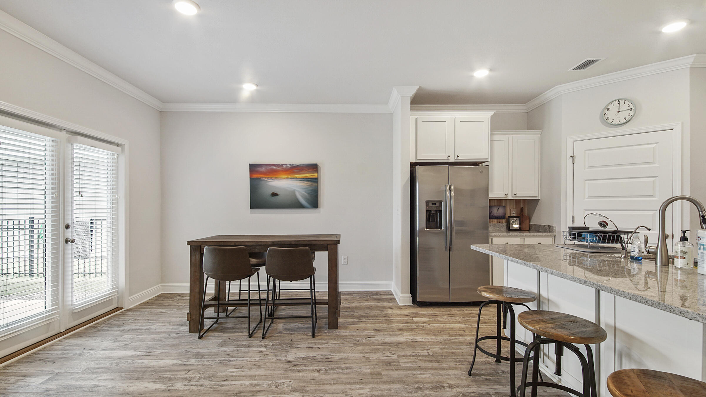 158 Lightning Bug Lane Freeport, FL 32439 - Photo 11 of 23 a kitchen with a refrigerator and table chair