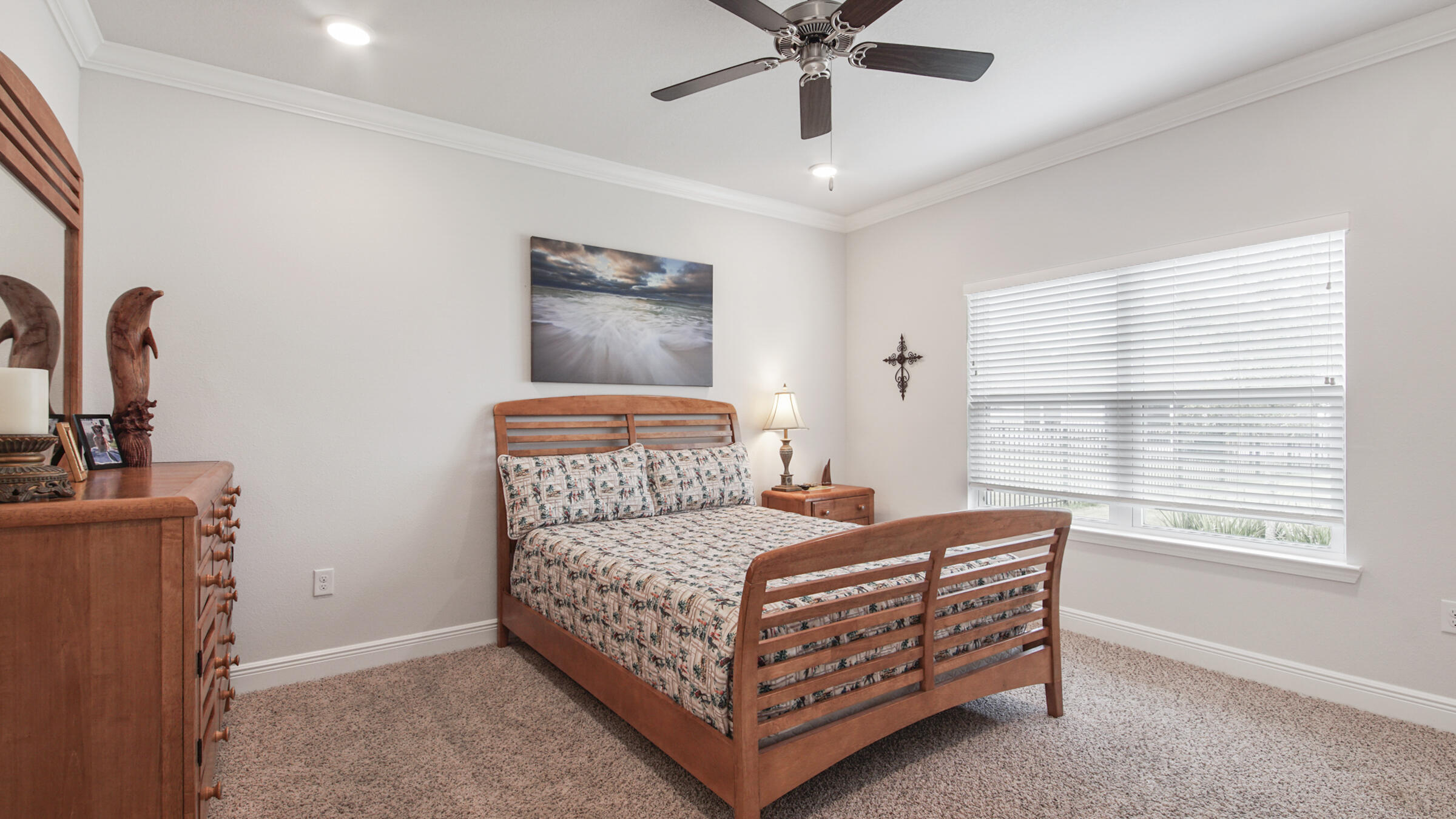 158 Lightning Bug Lane Freeport, FL 32439 - Photo 15 of 23 a bedroom with a bed and a chandelier