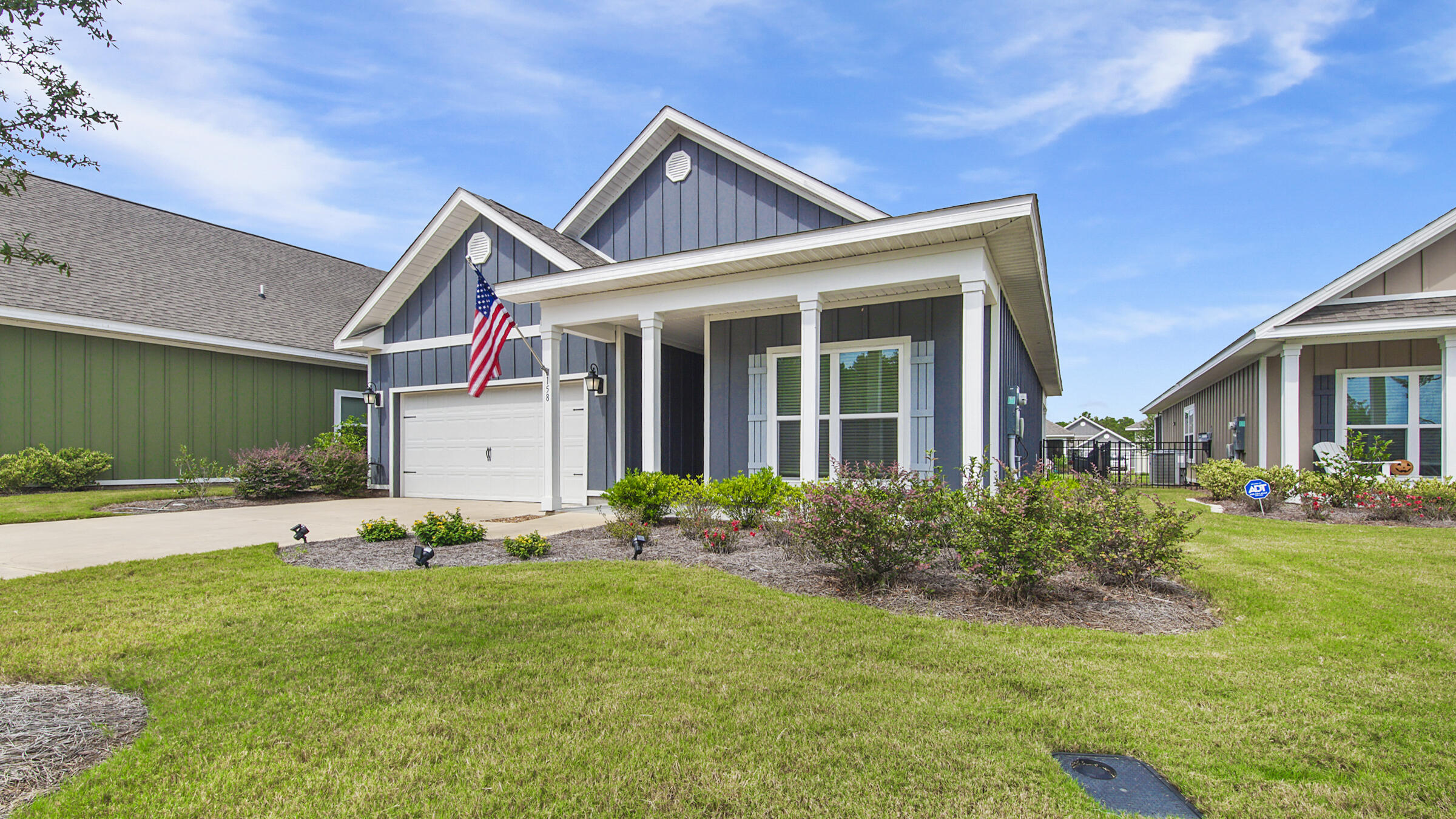 158 Lightning Bug Lane Freeport, FL 32439 - Photo 2 of 23 a front view of a house with garden