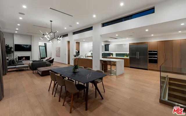 a large kitchen with a table and chairs