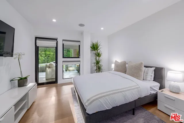 a bedroom with a large bed and a large window