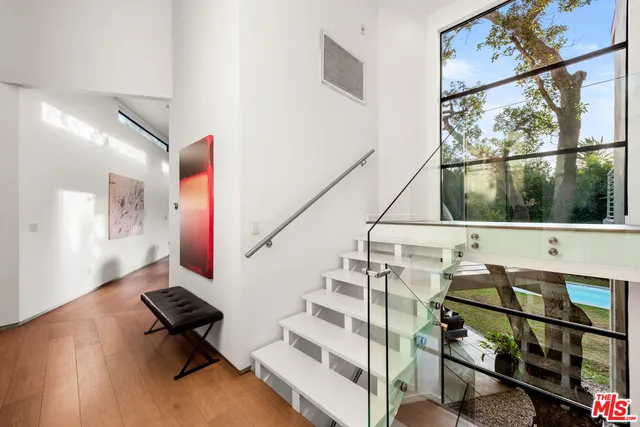 a view of entryway and hall with wooden floor