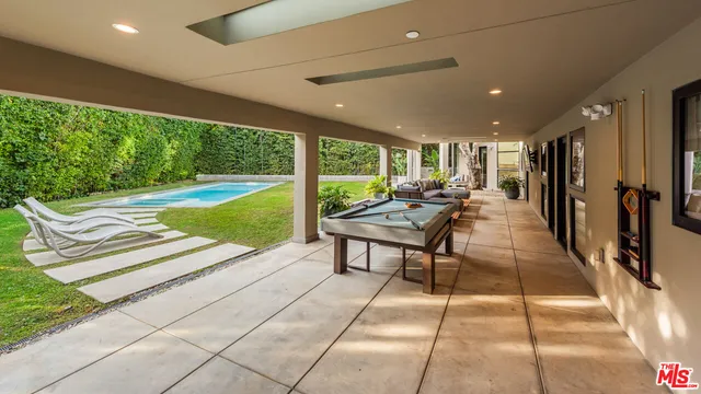 a view of a patio with a table and chairs