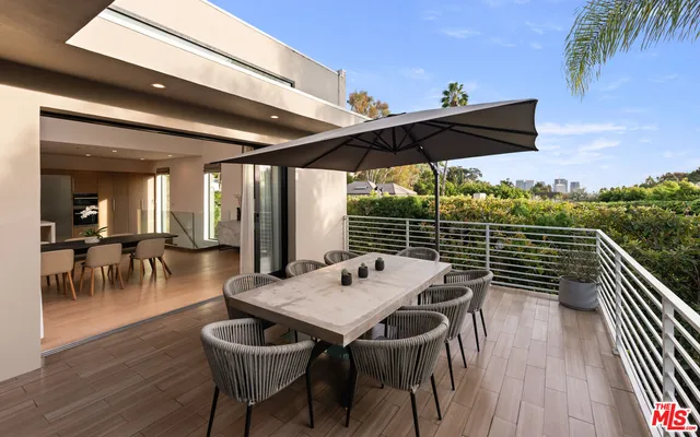 a view of a patio with a table and chairs