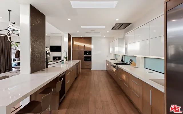 a large kitchen with kitchen island a large counter space a sink and stainless steel appliances