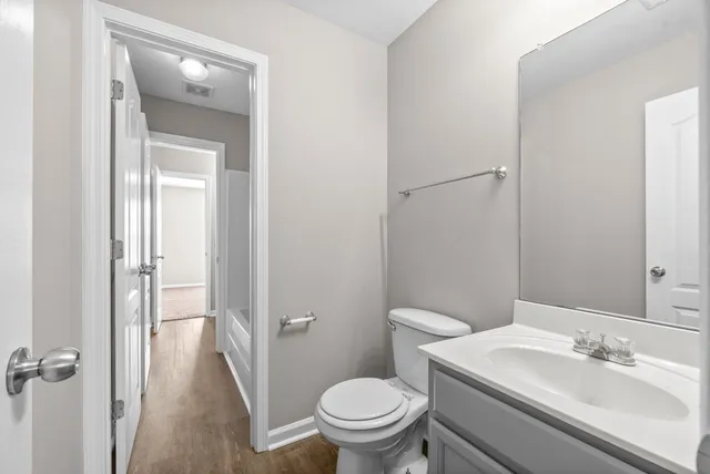 a bathroom with a sink toilet and vanity