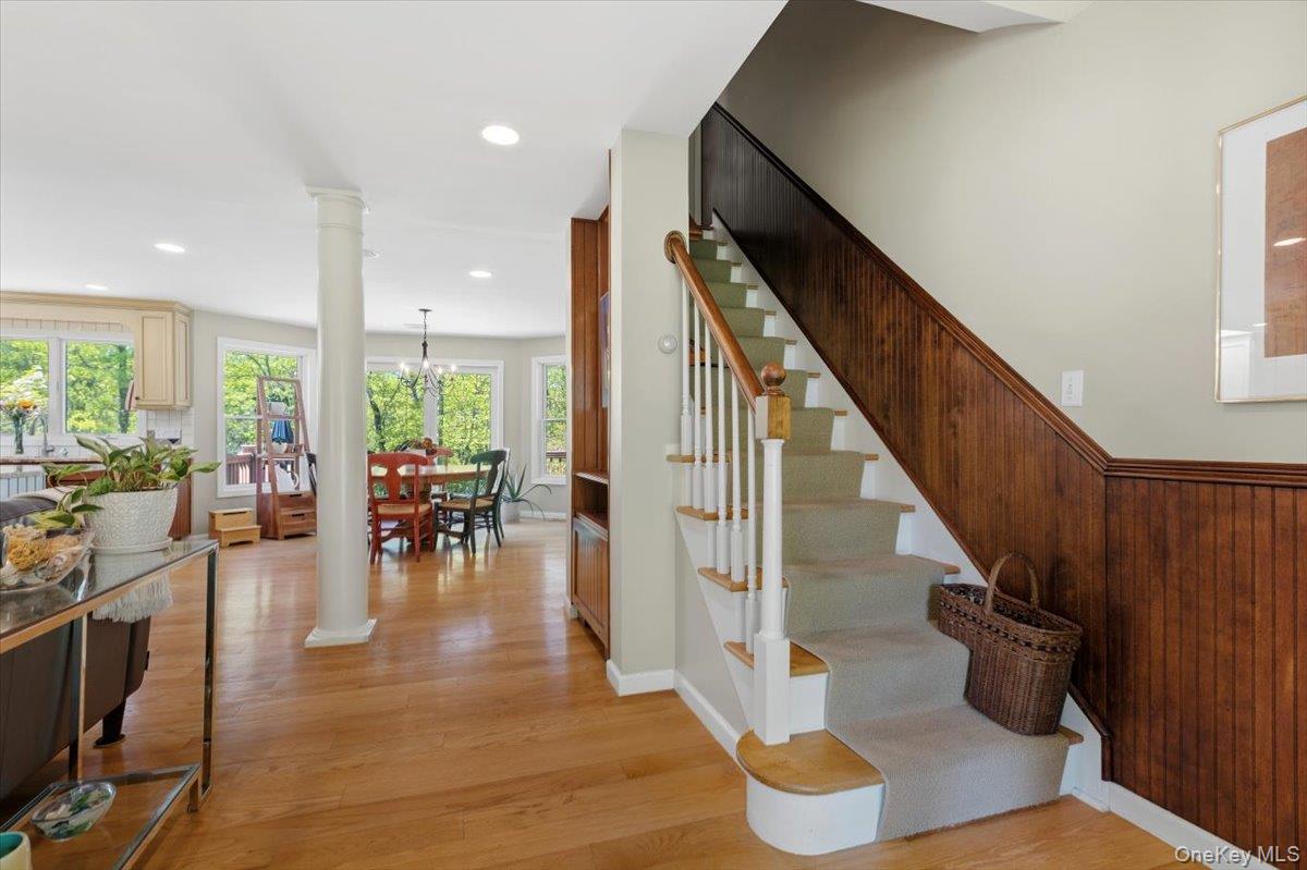 119 Edgewood Road Ossining, NY 10562 - Photo 45 of 50 From the Entry foyer you can see straight through a wall of windows to the backyard! The open floor plan offers a view of the side staircase to the second level, the Dining Area straight ahead, the updated Kitchen to the far left and the Living room directly to your left. Gleaming hardwood floors throughout both levels, and loads of custom designed built-ins add warmth and character.